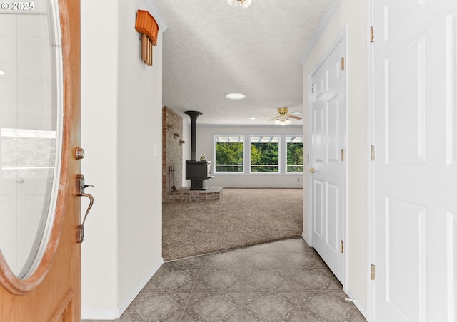 18183 SE Richey Rd, Gresham, OR 97080 - foyer with a wood stove, light carpet, ceiling fan, and a textured ceiling