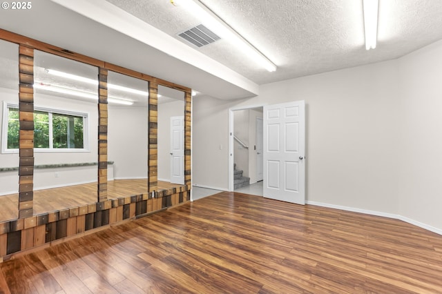 18183 SE Richey Rd, Gresham, OR 97080 - unfurnished room featuring a textured ceiling, wood finished floors, and stairway