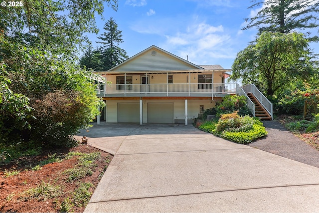 18183 SE Richey Rd, Gresham, OR 97080 - view of front of house featuring stairway, concrete driveway, a garage, and covered porch