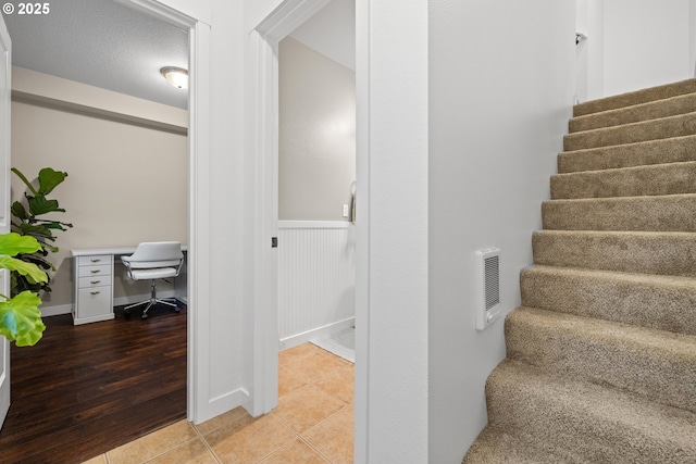 stairs featuring tile patterned floors