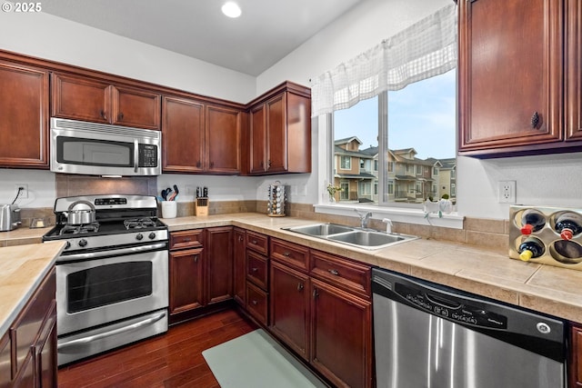 kitchen with sink, stainless steel appliances, and dark hardwood / wood-style floors