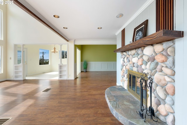 66599 Quail Rd, North Bend, OR 97459 - living room with a fireplace, crown molding, wood finished floors, a decorative wall, and recessed lighting