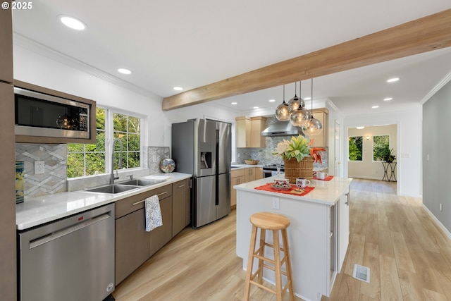 66599 Quail Rd, North Bend, OR 97459 - kitchen with appliances with stainless steel finishes, a sink, light wood finished floors, crown molding, and light countertops
