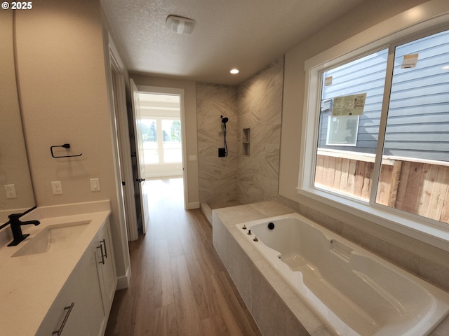 5602 N 93rd Ave Unit Lt205, Camas, WA 98607 - bathroom featuring a bath, vanity, wood finished floors, a tile shower, and recessed lighting