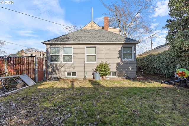 rear view of house featuring a lawn