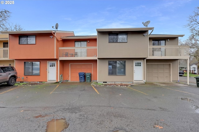 multi unit property featuring a garage, crawl space, and a balcony