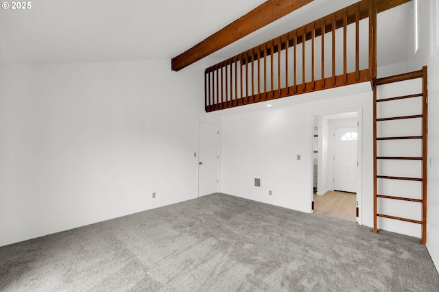 unfurnished living room with light carpet, stairs, visible vents, and beam ceiling