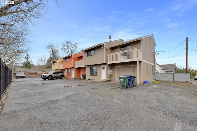 exterior space featuring a garage and fence