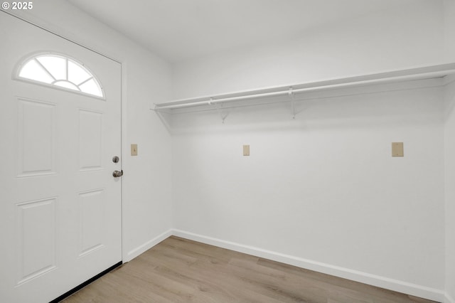 interior space with light wood finished floors and baseboards