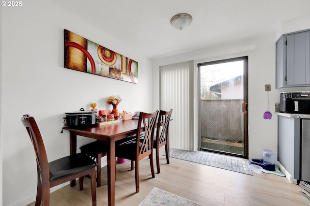 dining space featuring light wood-style flooring