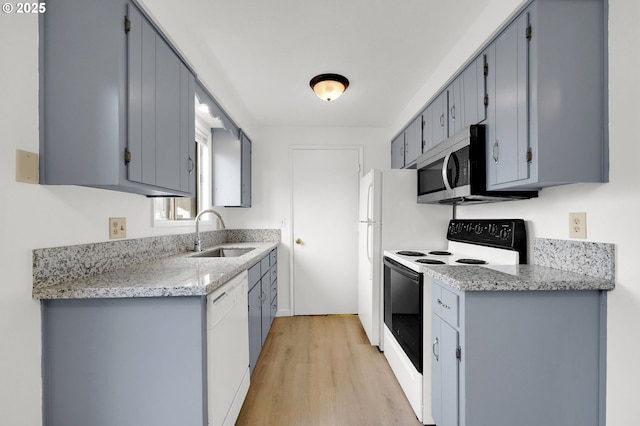 kitchen with electric range, stainless steel microwave, white dishwasher, gray cabinetry, and a sink