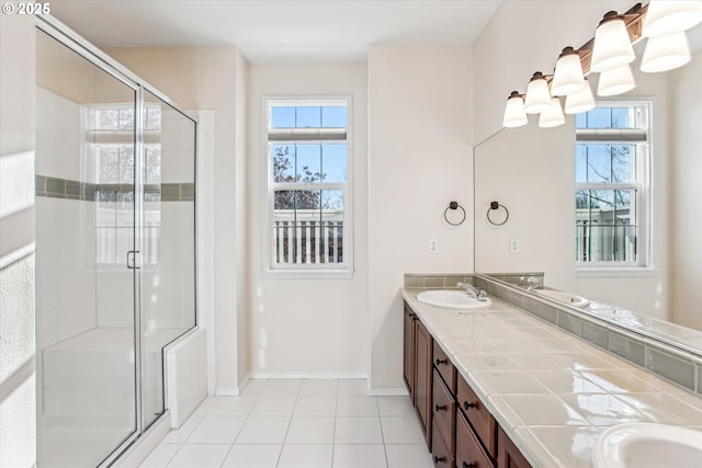 bathroom featuring tile patterned floors, vanity, and a shower with shower door