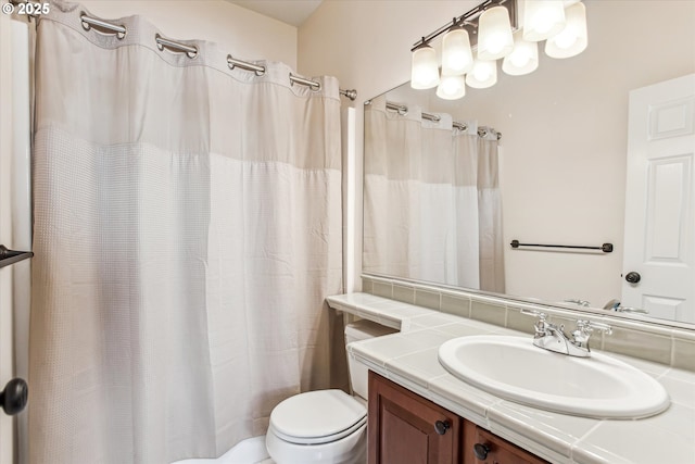 bathroom with toilet and vanity