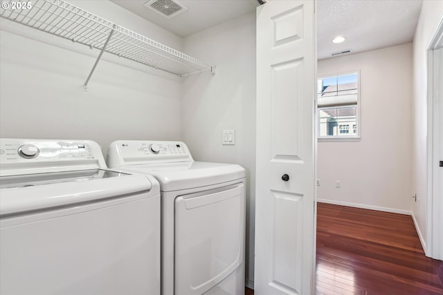 washroom featuring separate washer and dryer and dark hardwood / wood-style floors