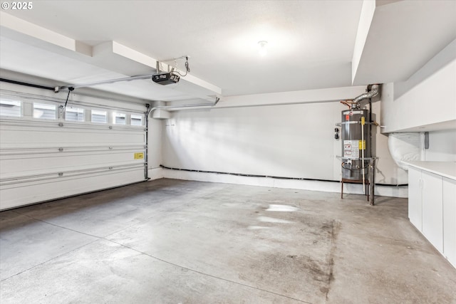 garage with strapped water heater and a garage door opener