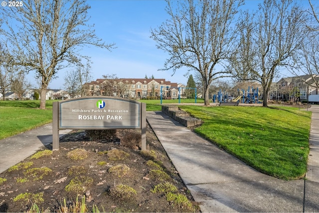 view of property's community with a yard and a playground