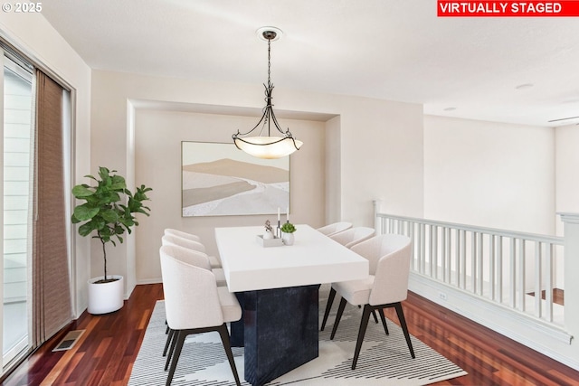 dining space with dark wood-type flooring