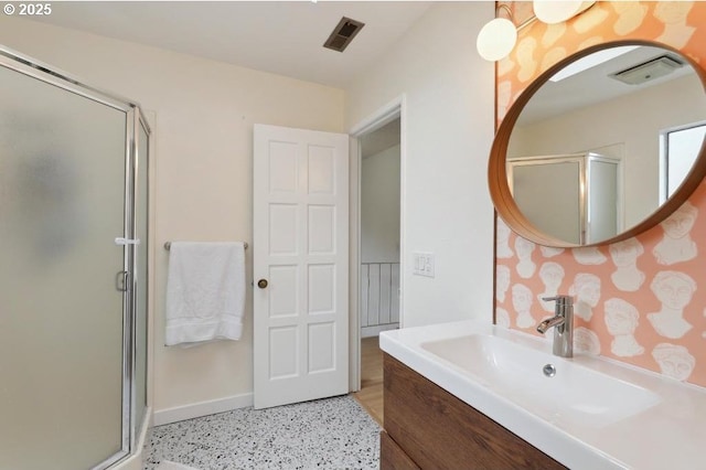 bathroom featuring visible vents, baseboards, speckled floor, and a stall shower