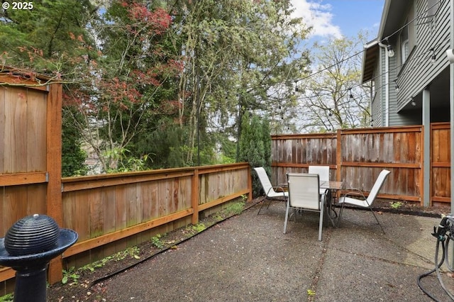 view of patio featuring a fenced backyard and outdoor dining area