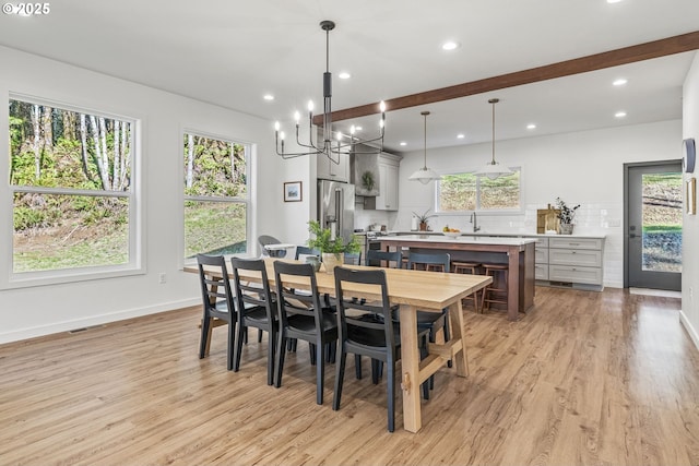 dining space with visible vents, light wood-style flooring, and a healthy amount of sunlight