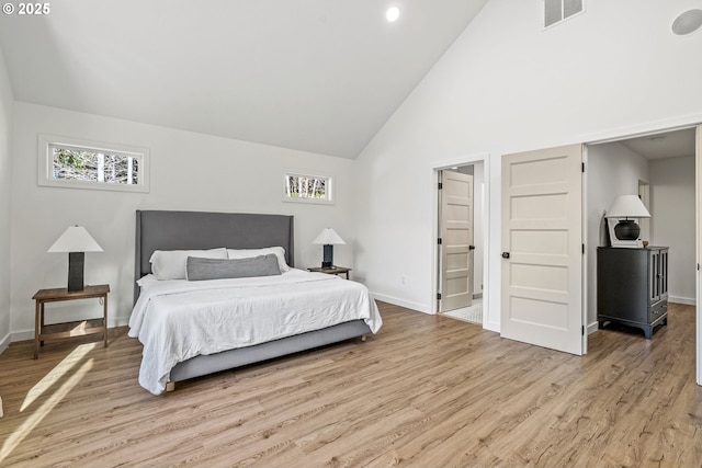 bedroom with multiple windows, baseboards, visible vents, and light wood-type flooring