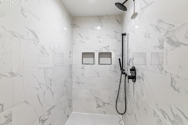 bathroom featuring a marble finish shower