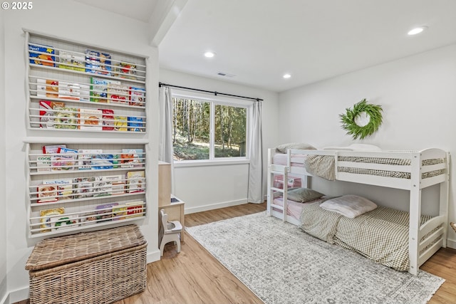 bedroom with recessed lighting, wood finished floors, visible vents, and baseboards