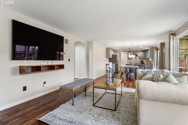 17006 SE 6th St, Vancouver, WA 98684 - living area with wood finished floors, baseboards, arched walkways, a chandelier, and recessed lighting