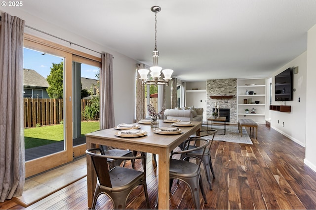 17006 SE 6th St, Vancouver, WA 98684 - dining area with a stone fireplace, a chandelier, hardwood / wood-style floors, baseboards, and built in features