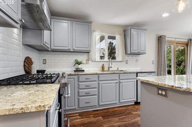 17006 SE 6th St, Vancouver, WA 98684 - kitchen with gray cabinets, a sink, wall chimney exhaust hood, appliances with stainless steel finishes, and tasteful backsplash
