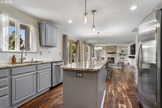 17006 SE 6th St, Vancouver, WA 98684 - kitchen with gray cabinets, appliances with stainless steel finishes, open floor plan, a center island, and dark wood-style flooring