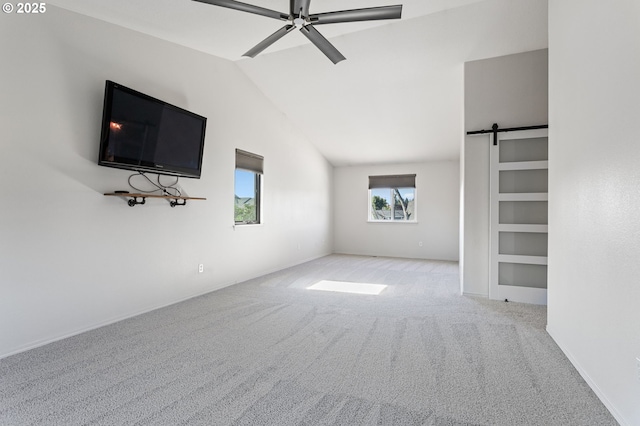 17006 SE 6th St, Vancouver, WA 98684 - unfurnished living room featuring carpet floors, a barn door, lofted ceiling, ceiling fan, and baseboards