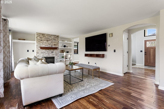 17006 SE 6th St, Vancouver, WA 98684 - living area with arched walkways, a fireplace, dark wood-style flooring, and baseboards