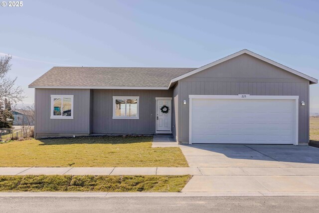 ranch-style house with a front yard and a garage