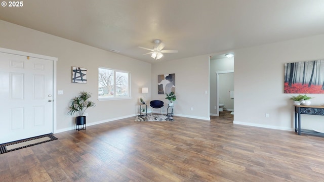 unfurnished office featuring ceiling fan, wood finished floors, visible vents, and baseboards