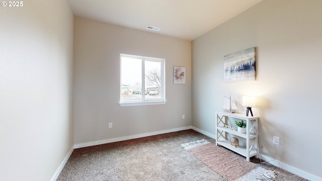 unfurnished room with carpet, visible vents, and baseboards