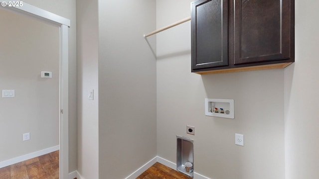 clothes washing area with cabinets, dark hardwood / wood-style floors, hookup for a washing machine, and electric dryer hookup