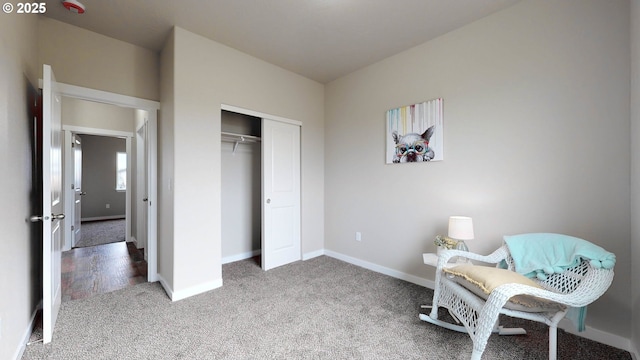 sitting room featuring carpet floors and baseboards