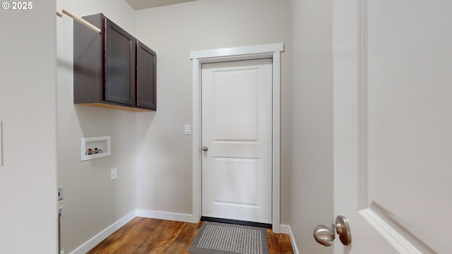 washroom with cabinet space, baseboards, dark wood-style floors, hookup for a washing machine, and hookup for an electric dryer