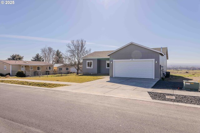 single story home with a front lawn, a garage, and central air condition unit