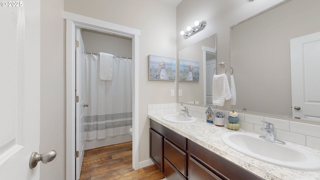 bathroom featuring toilet, vanity, wood-type flooring, and a shower with shower curtain