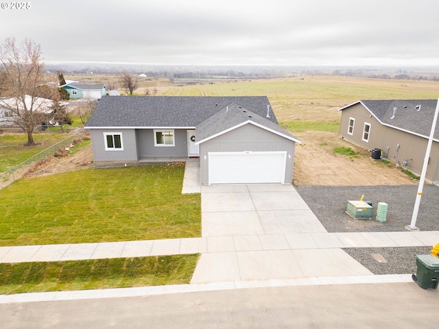 ranch-style house featuring a garage, a front lawn, and central air condition unit