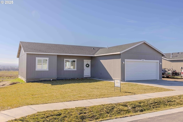 ranch-style house featuring an attached garage, driveway, a shingled roof, and a front yard