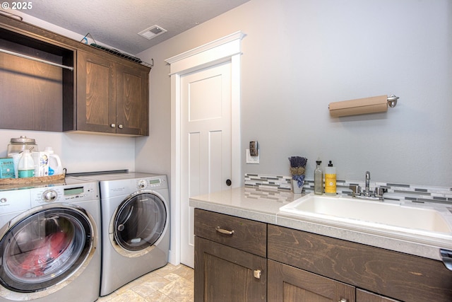 15928 Stables Pl, Oregon City, OR 97045 - clothes washing area with cabinet space, washer and dryer, a sink, stone finish flooring, and visible vents