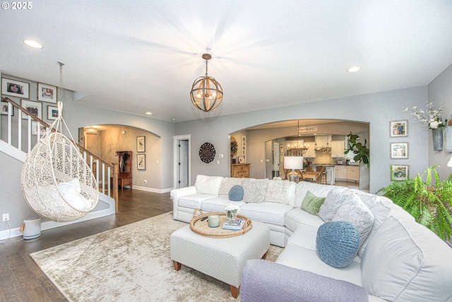 15928 Stables Pl, Oregon City, OR 97045 - living area with stairs, arched walkways, an inviting chandelier, and wood finished floors