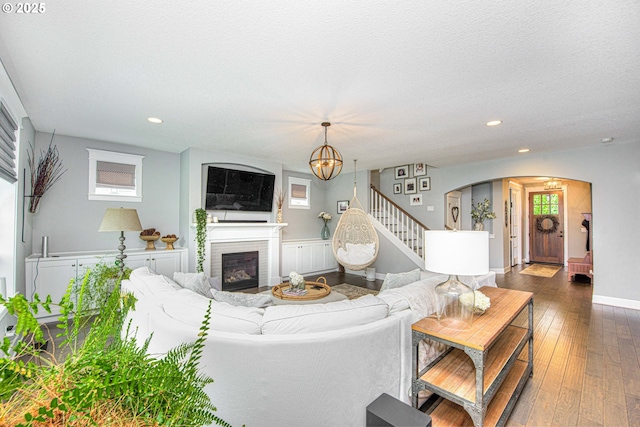 15928 Stables Pl, Oregon City, OR 97045 - living area featuring a fireplace, arched walkways, a chandelier, hardwood / wood-style floors, and recessed lighting