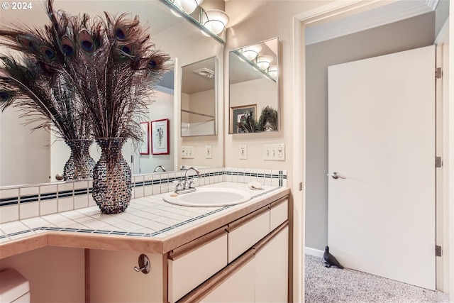 bathroom with vanity and ornamental molding