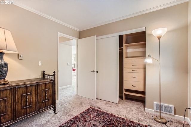 bedroom featuring light colored carpet, crown molding, and a closet