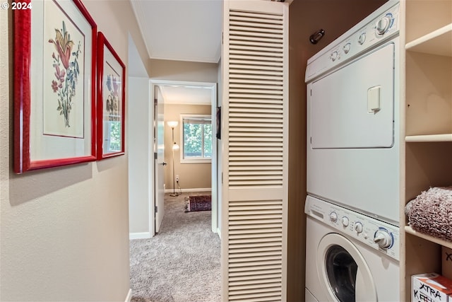 clothes washing area featuring carpet, stacked washer / dryer, and ornamental molding