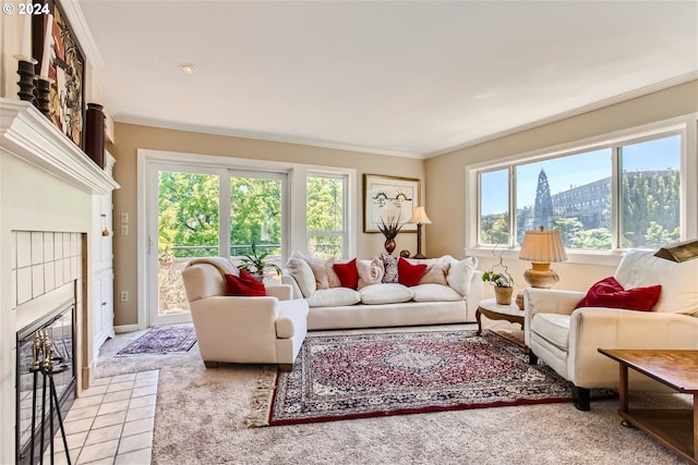 carpeted living room featuring a tile fireplace and ornamental molding